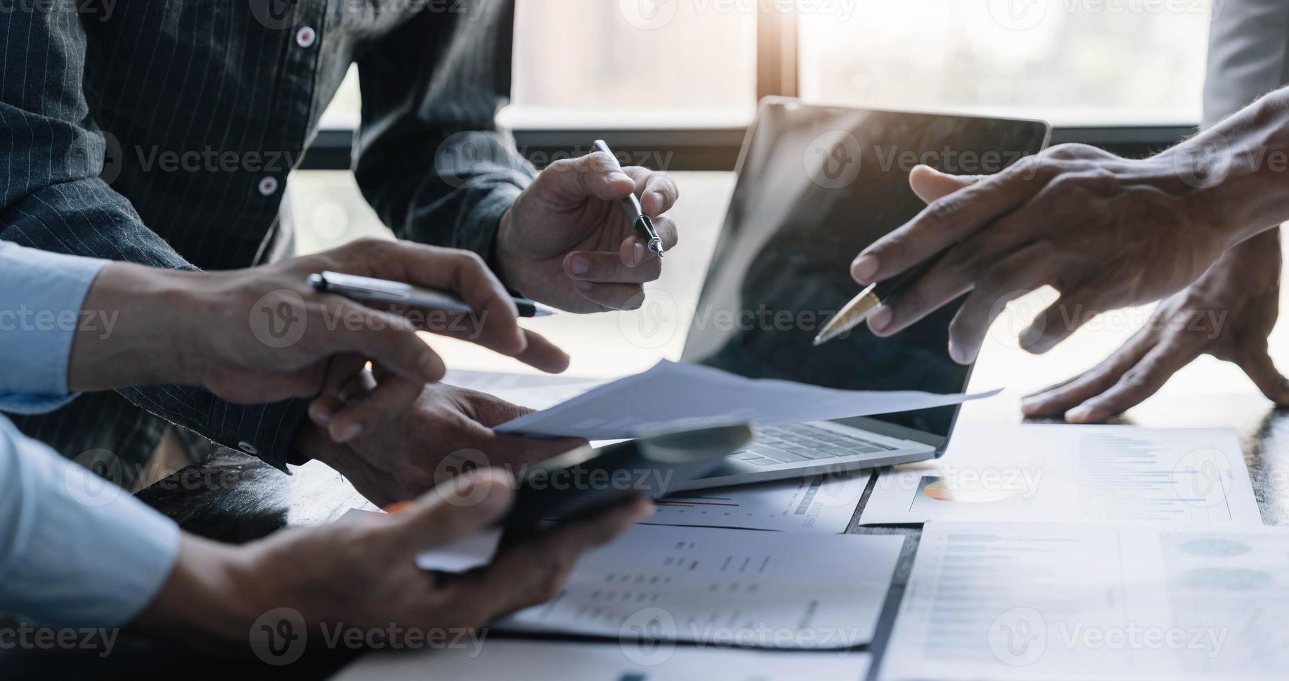 Business People Meeting using laptop computer,calculator,notebook,stock market chart paper for analysis Plans to improve quality next month. Conference Discussion Corporate Concept photo