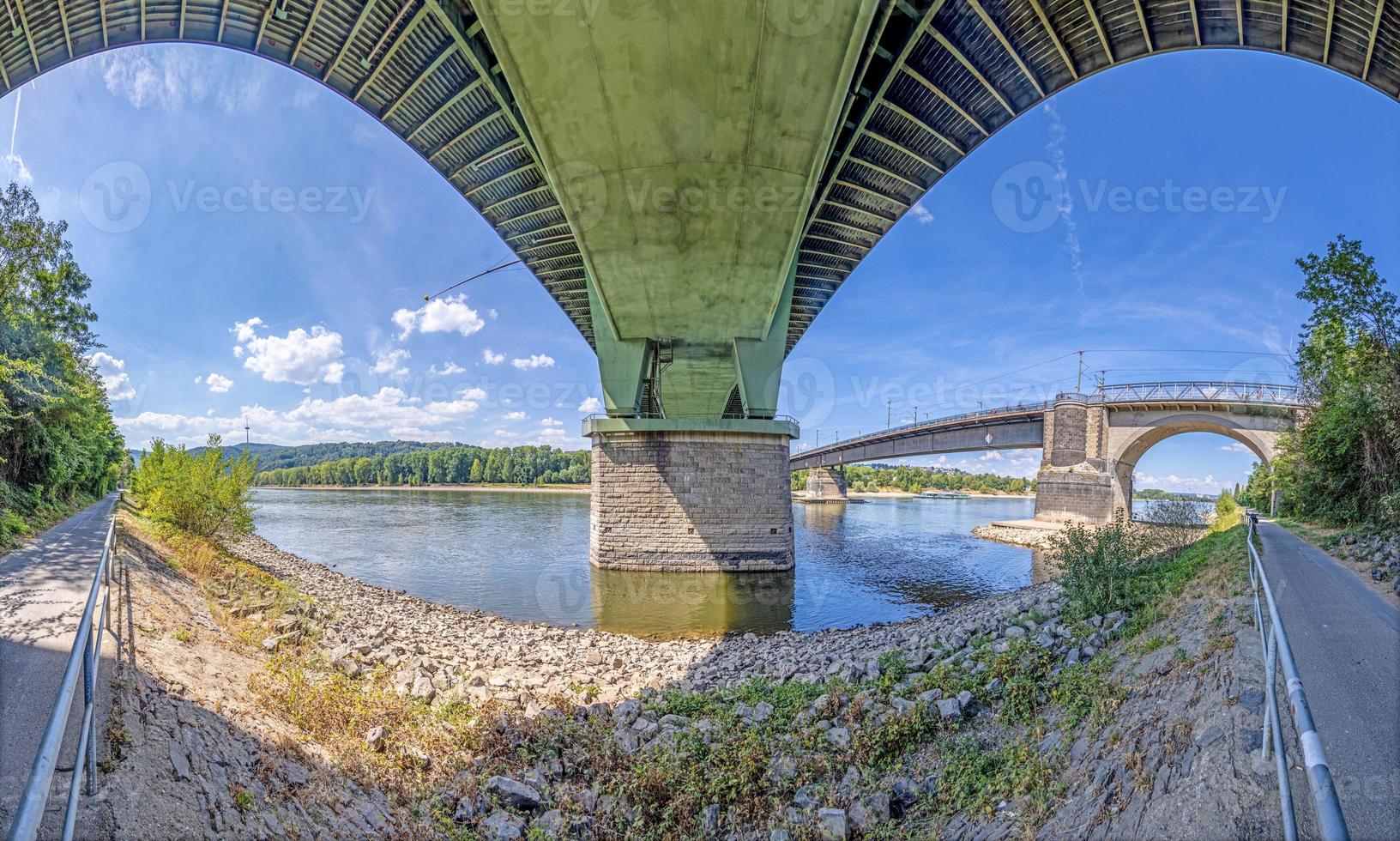 Wide angle view of a highway bridge from below with symetric geometries photo