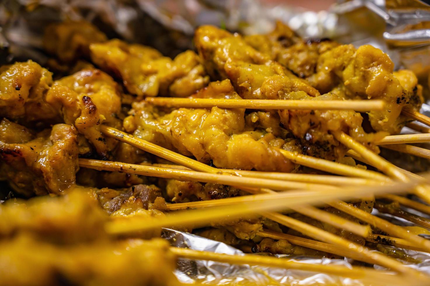 Close Pork Satay Skewer with dried bamboo in the Foy.This Thai pork satay recipe is easy to make and can be eaten as an appetizer, snack, or main course dish. photo