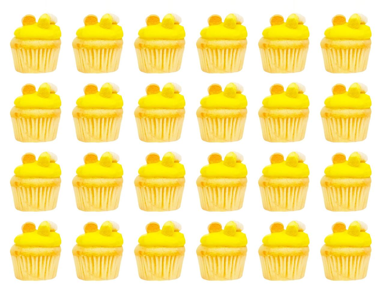 Yellow or pineapple cupcakes pattern isolated on white background. Fresh sweet bakery baked and homemade. Colorful dessert and funny wallpaper concept. photo