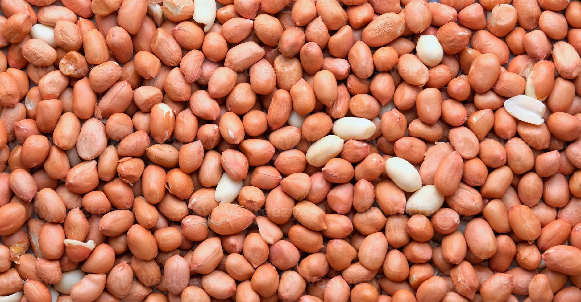 Top view of Raw Peanuts background. Pile of raw peanuts beans texture. photo