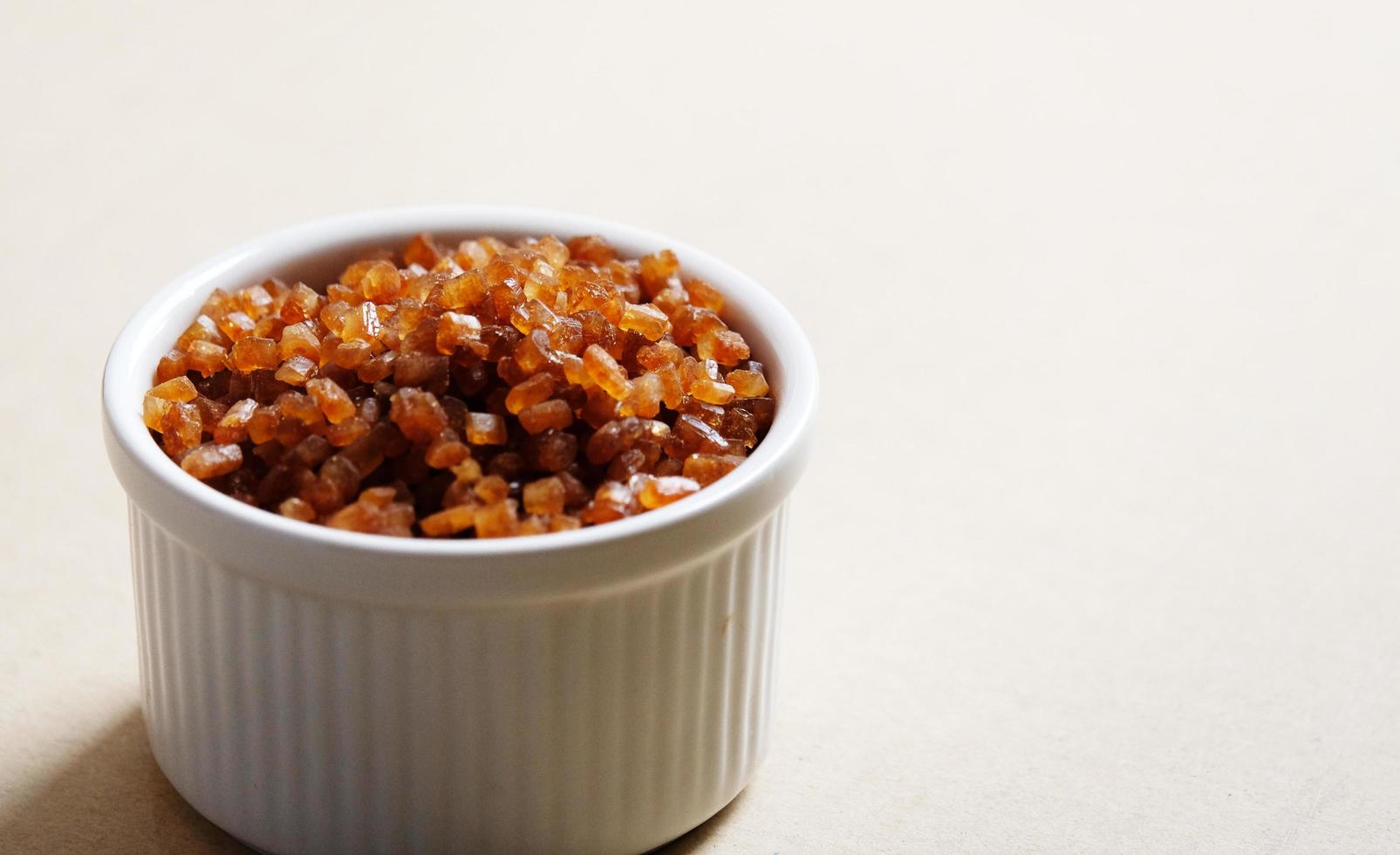 Bowl of Crystal Sugar. Brown cane sugar, caramel sugar photo