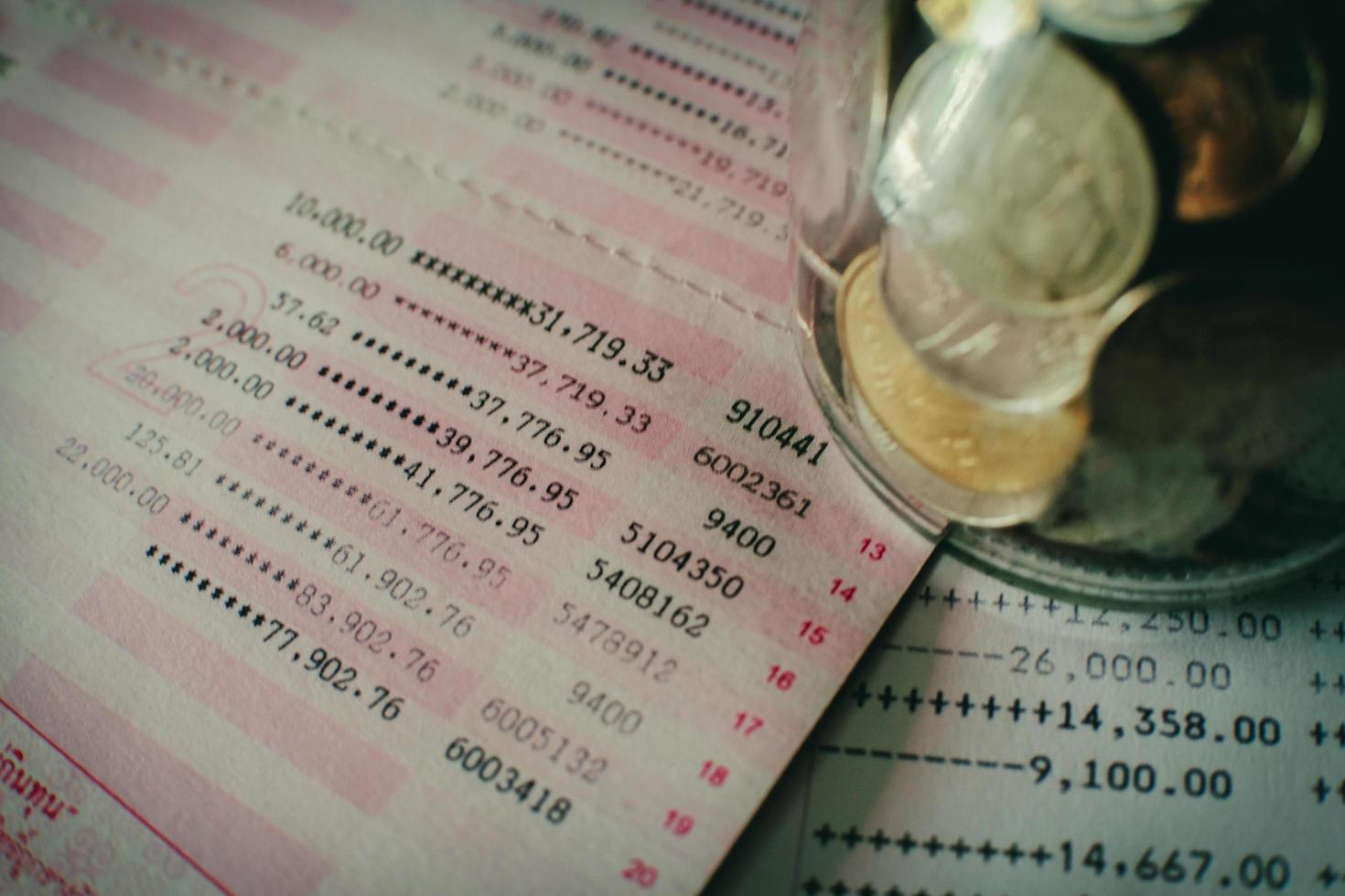 Saving account passbook with coin in a jar. business , finance , investment , saving and mortgage concept. photo