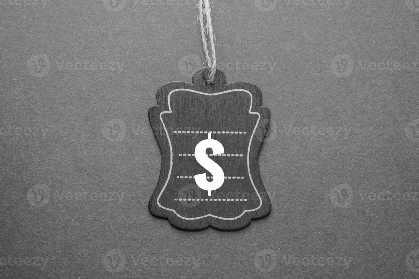 black price tag with dollar sign on the black background, black mockup photo