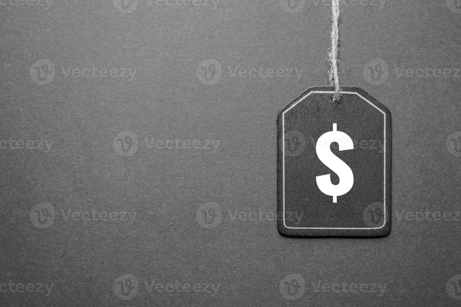 black price tag with dollar sign on the black background, black mockup photo