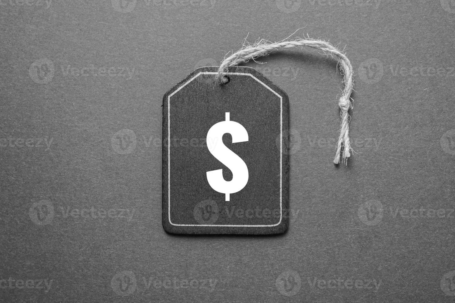 black price tag with dollar sign on the black background, black mockup photo