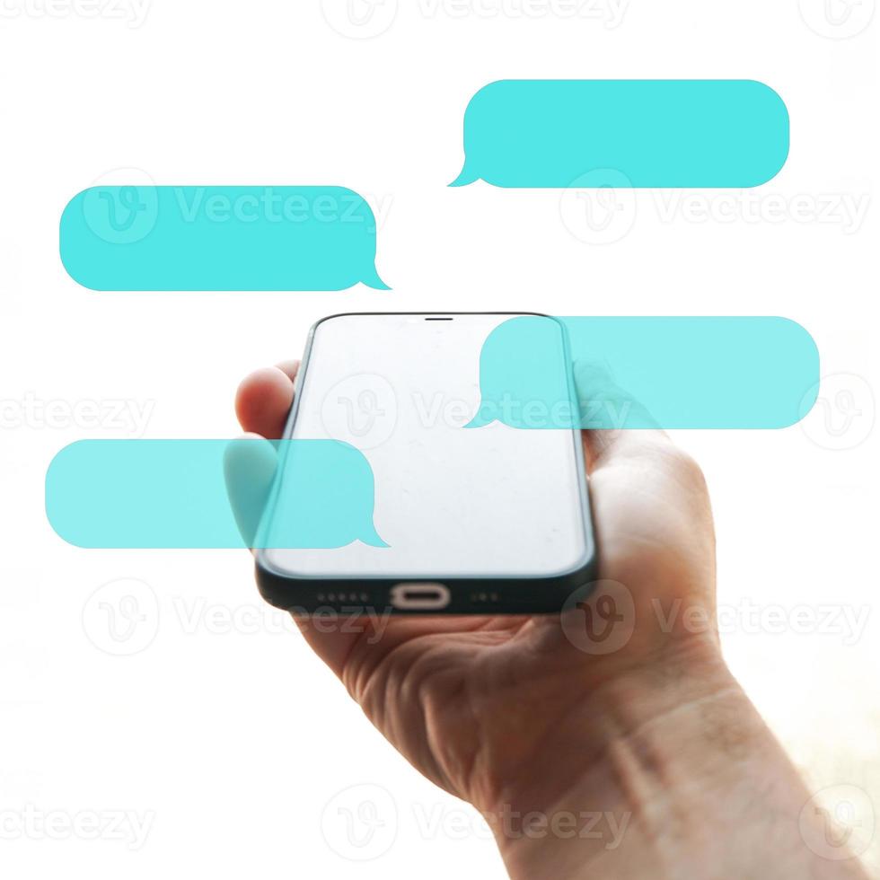 hand holding a smartphone with chat symbol, texting on the phone, phone addiction photo