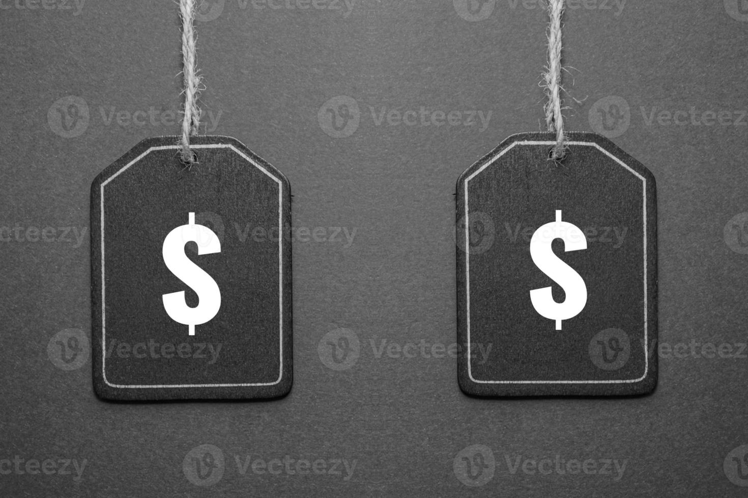 black price tag with dollar sign on the black background, black mockup photo