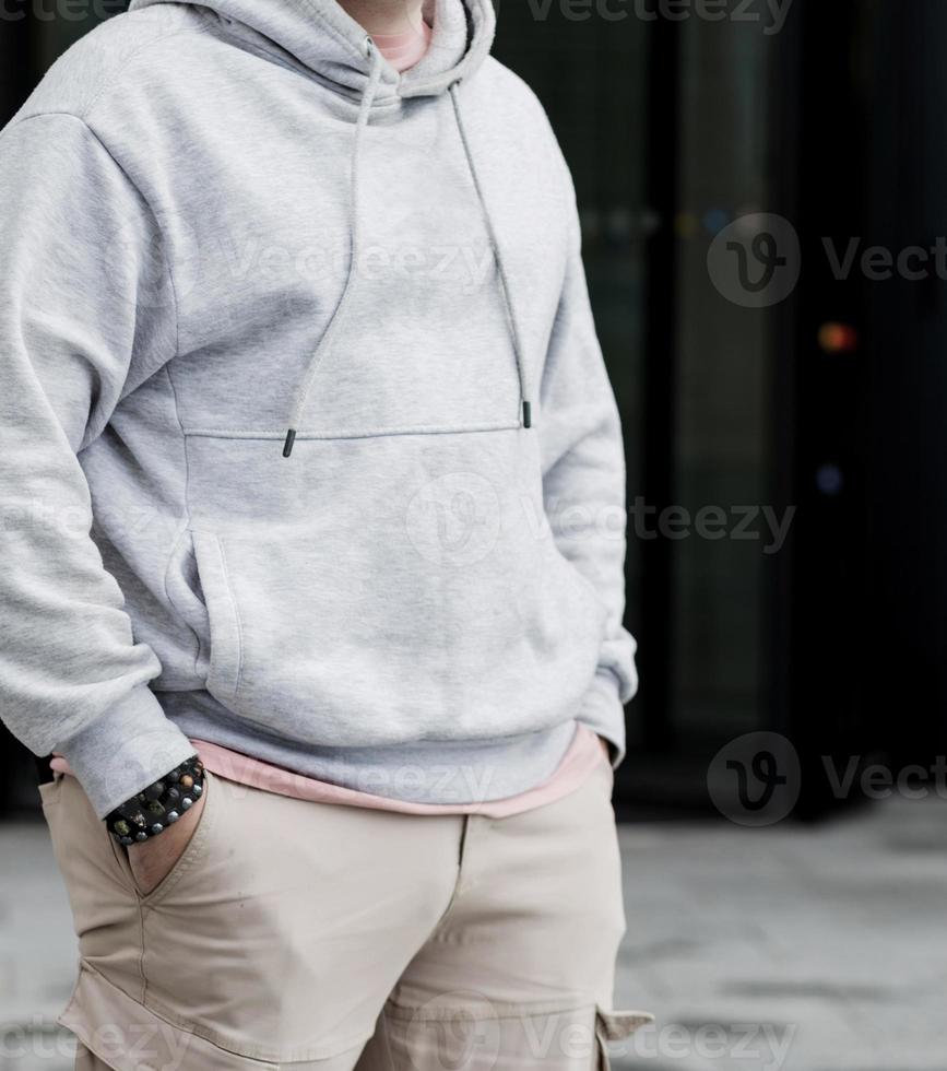 man wearing gray blank hoodie. photo