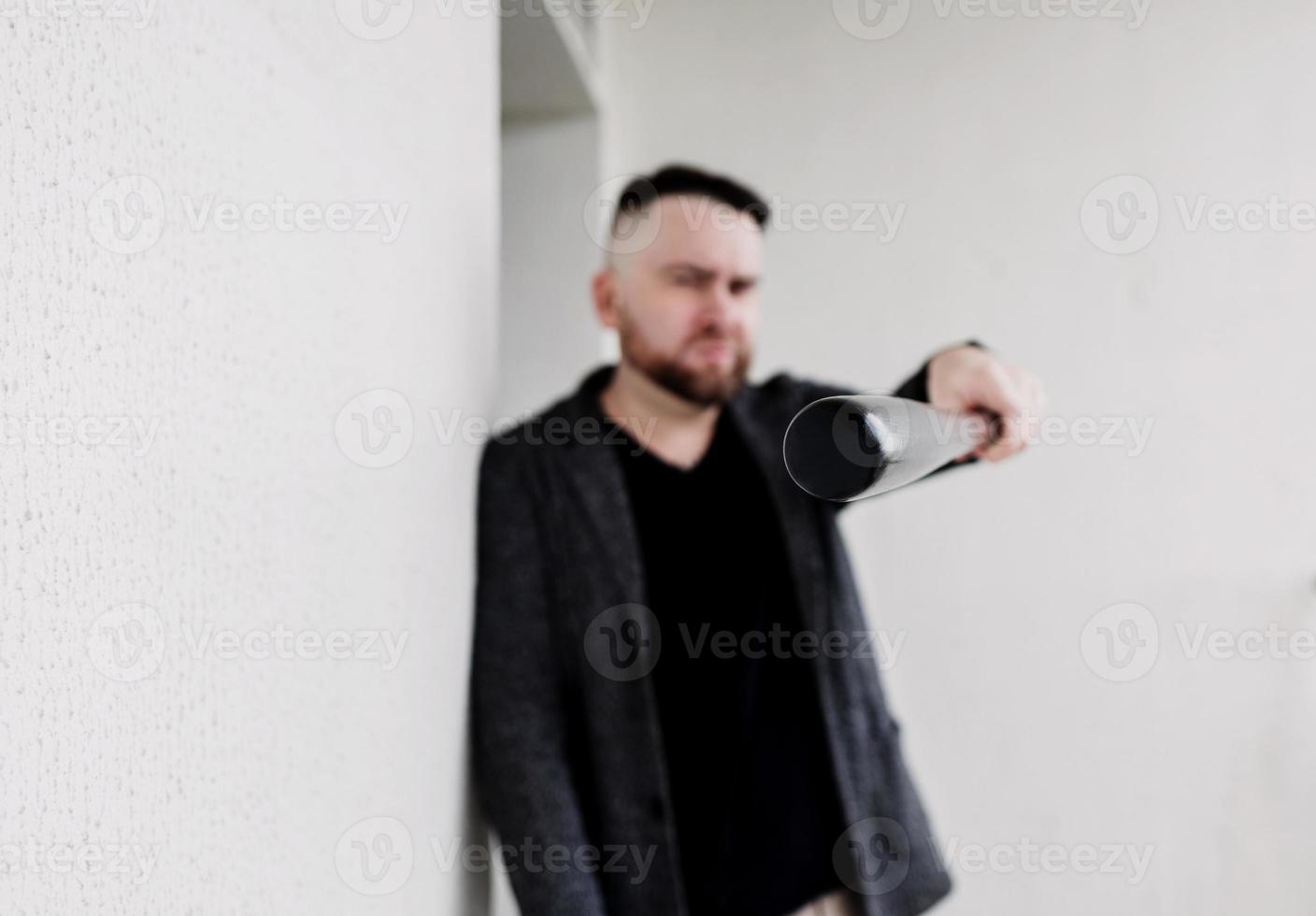 man points the bat at the camera photo