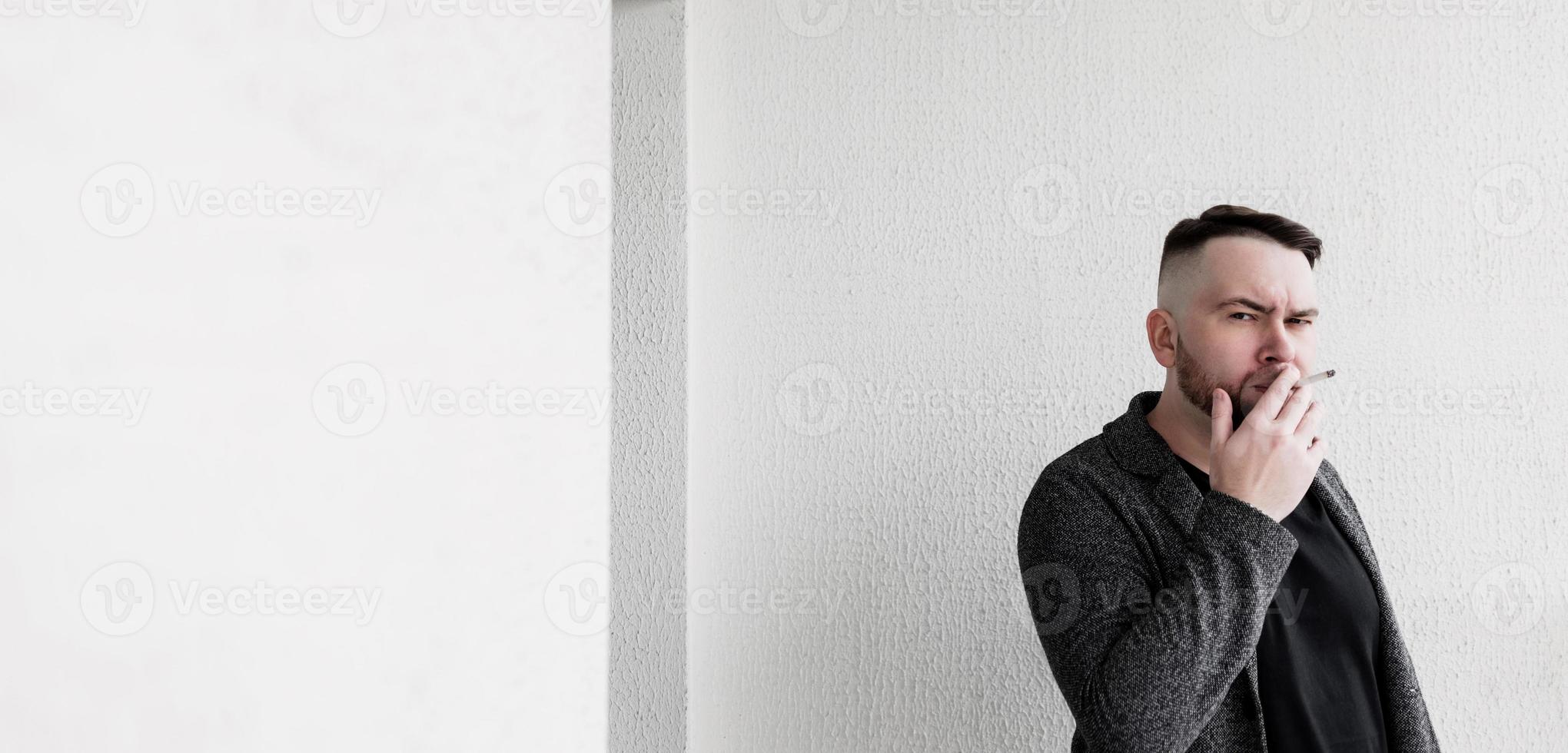 Cool bearded blowing smoke of cigarette photo