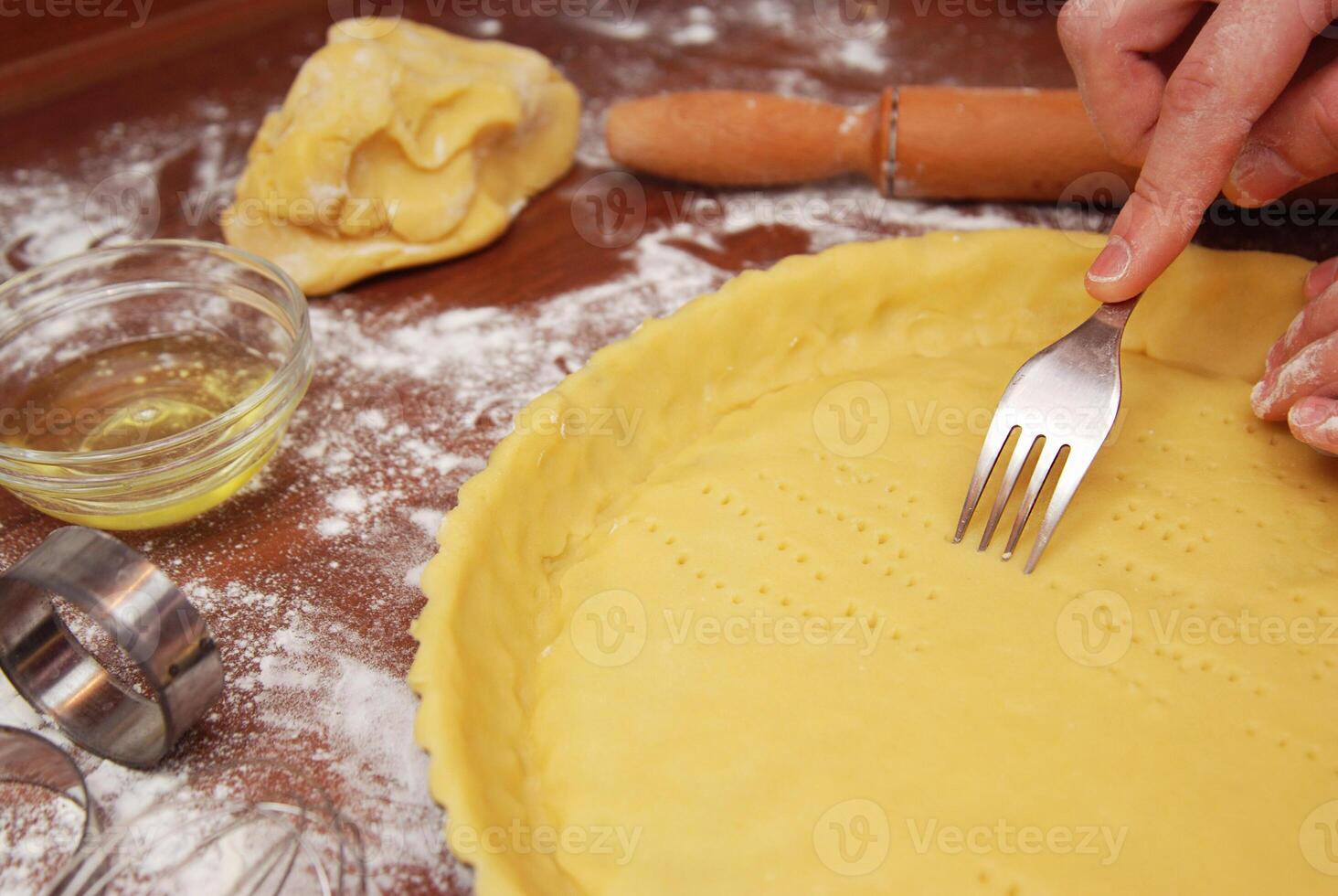 Food Process. Making Lemon Pie Tart Series. Men's hand Prick the Base of the Raw Pastry Case all