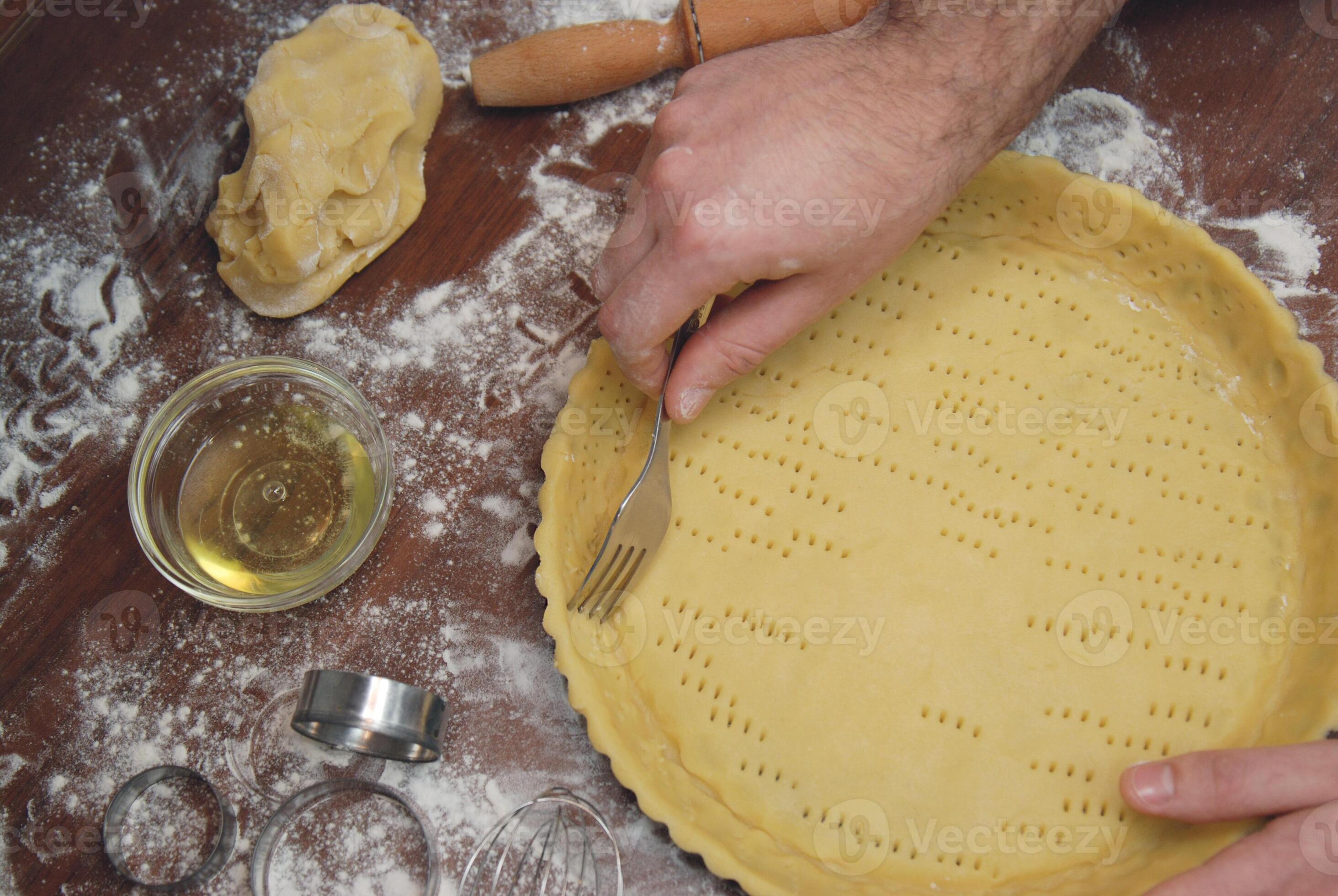 Prick the base of the pastry case all over with a fork. Making Pie Tart Series. 15931908 Stock
