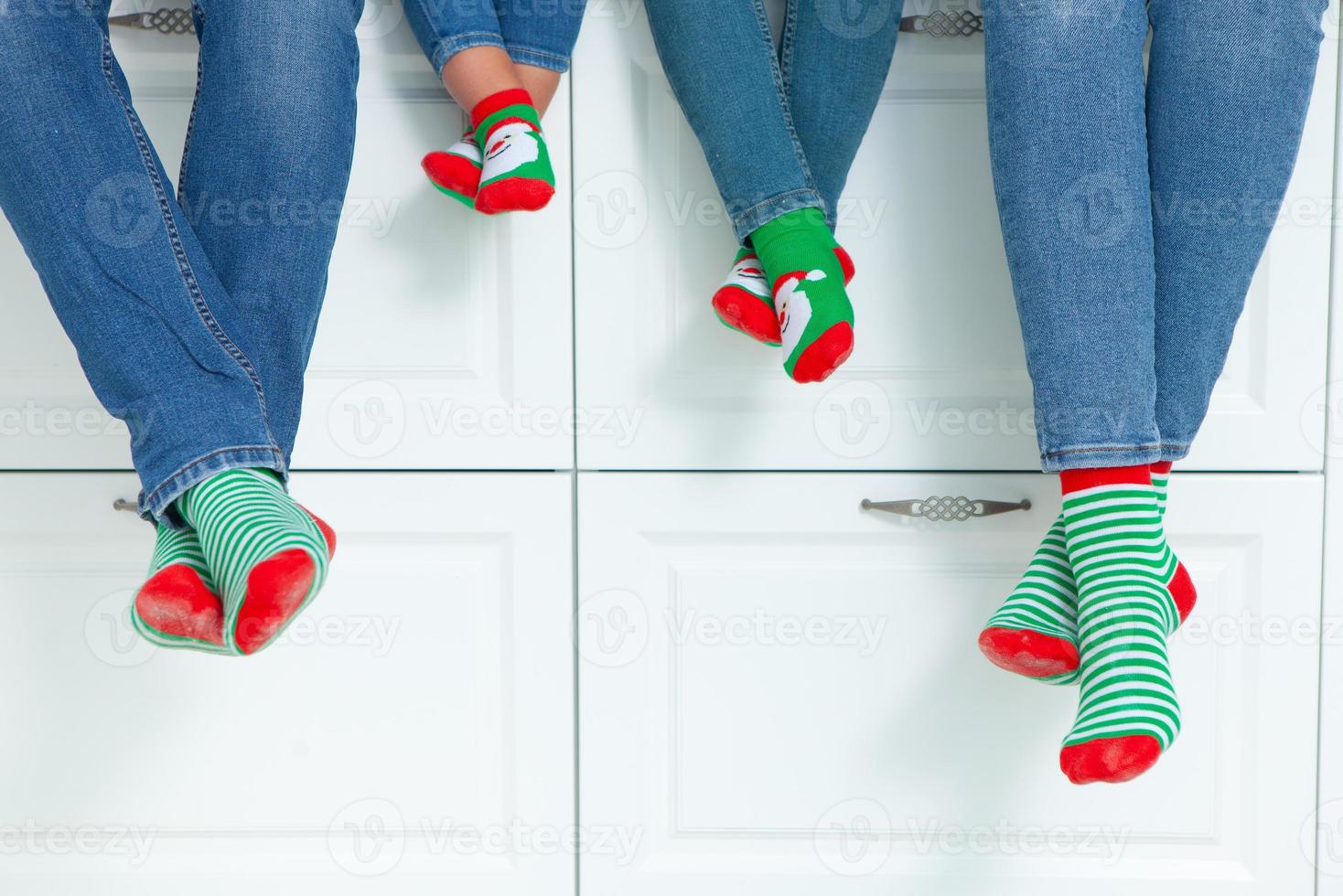 the concept of a happy family dressed in Christmas stockings in the kitchen photo