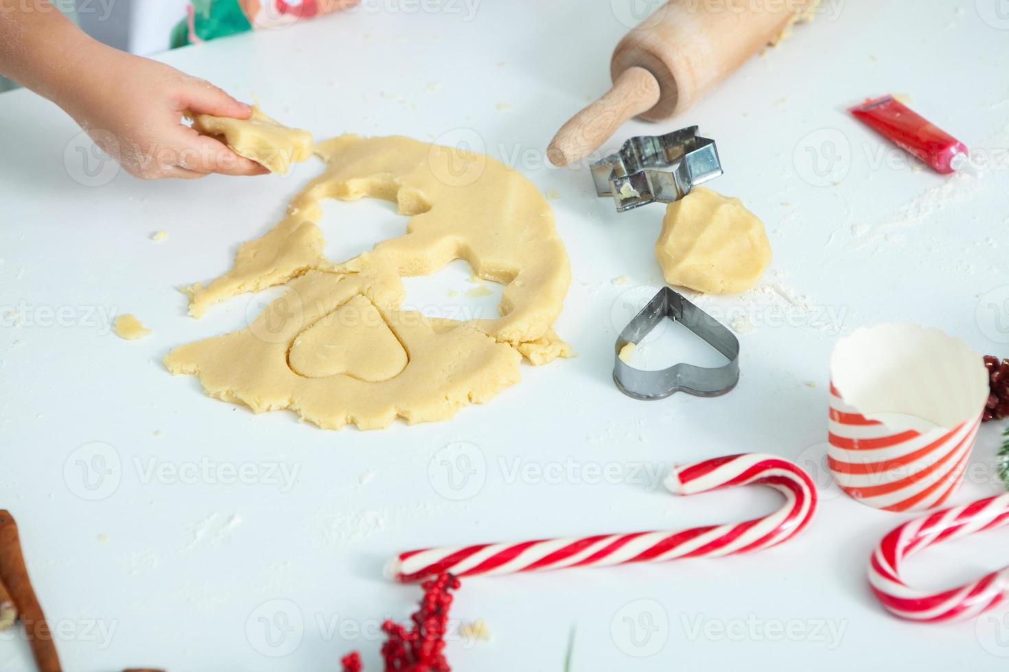 Family cooking homemade cakes. Moms and children hands holding cookie cutters. Family Cooking flat lay. Sweet home. Happiness concept. photo