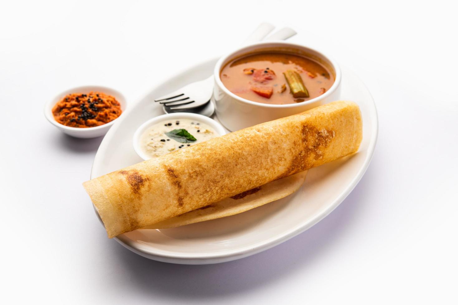 A dosa, also called dosai, dosey, or dosha, is a thin pancake in South Indian cuisine photo