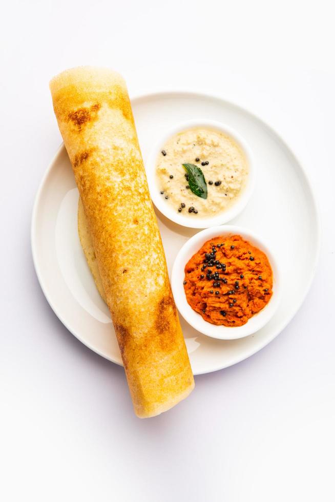 A dosa, also called dosai, dosey, or dosha, is a thin pancake in South Indian cuisine photo