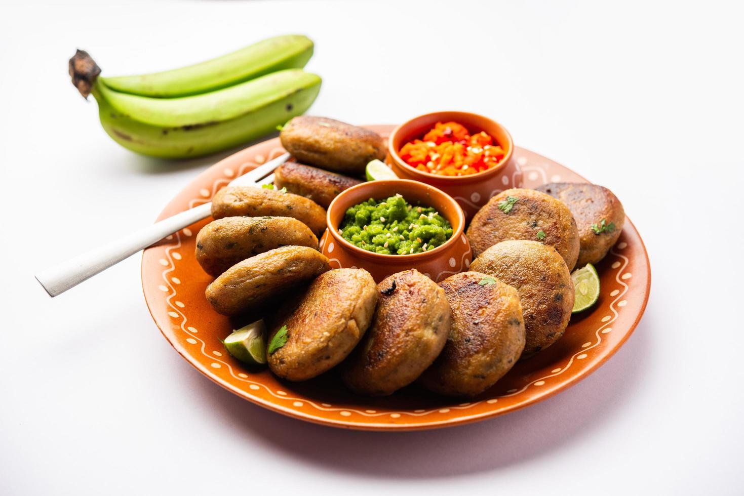 Raw Banana Cutlet also called plantain or kacche kele ki tikki or patties, served with chutney photo