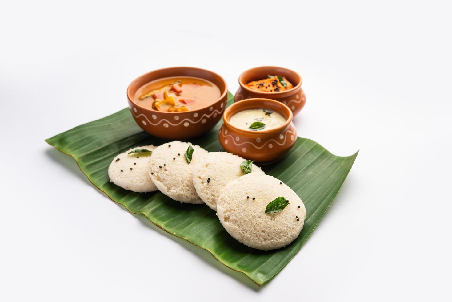 Idly sambar or Idli with Sambhar and green, red chutney. Popular South indian breakfast photo