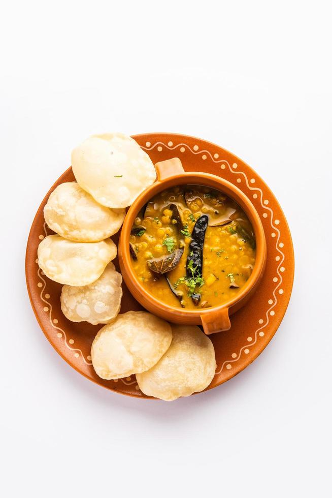 Luchi Cholar Dal or Fried bread made of flour served along with curried Chana or Bengal gram photo