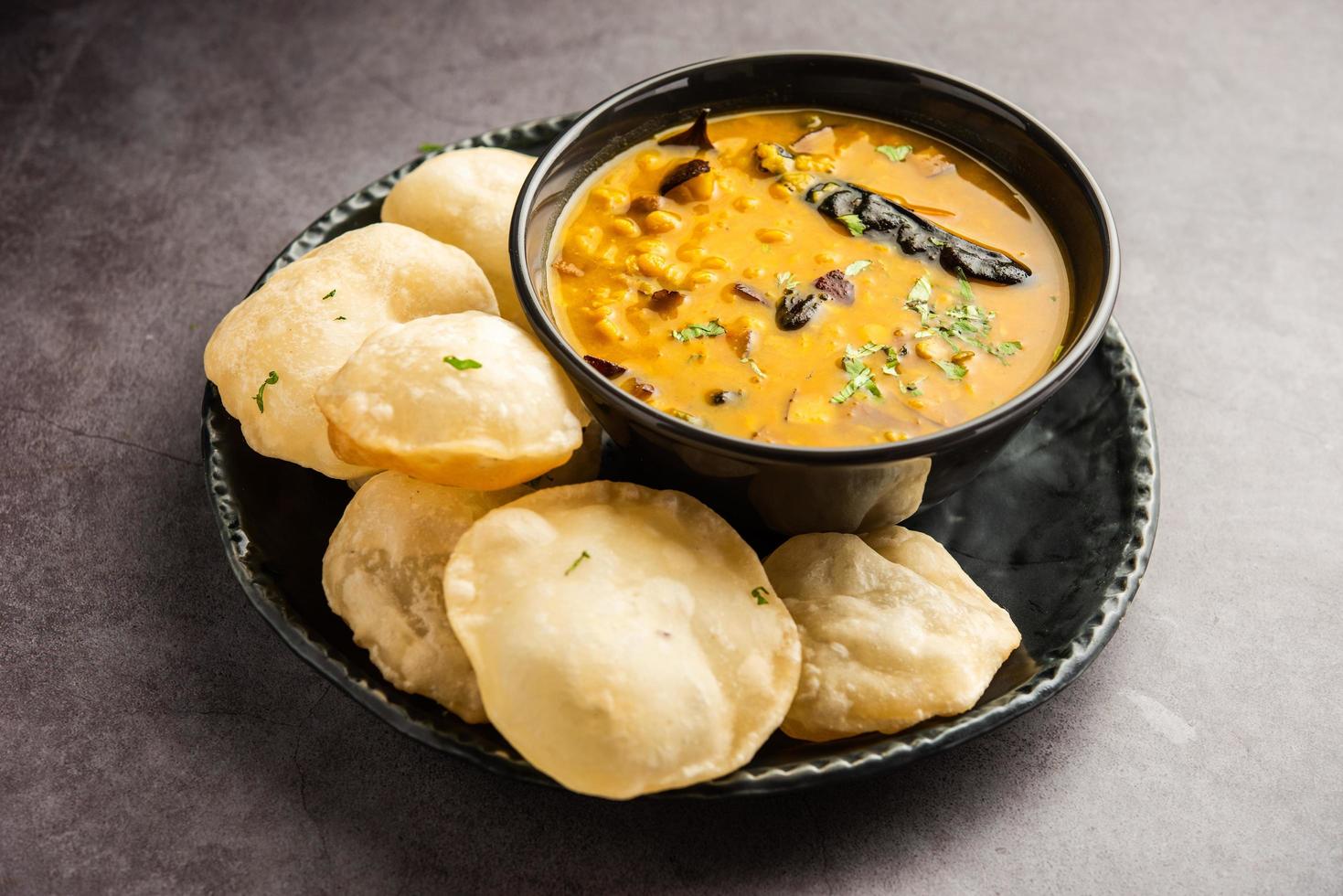 Luchi Cholar Dal or Fried bread made of flour served along with curried Chana or Bengal gram photo