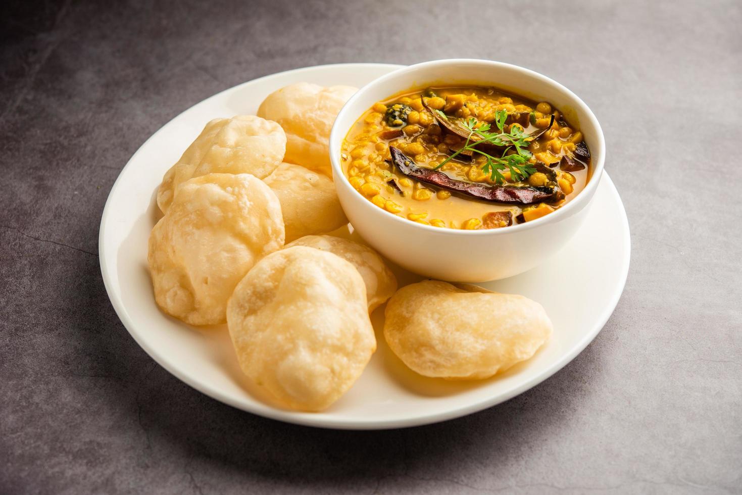 Luchi Cholar Dal or Fried bread made of flour served along with curried Chana or Bengal gram photo