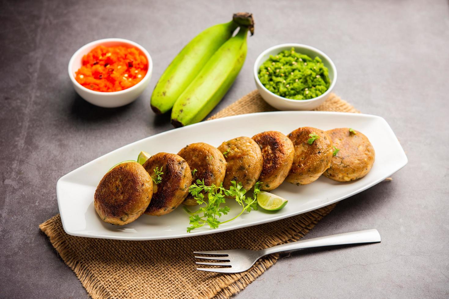 Raw Banana Cutlet also called plantain or kacche kele ki tikki or patties, served with chutney photo