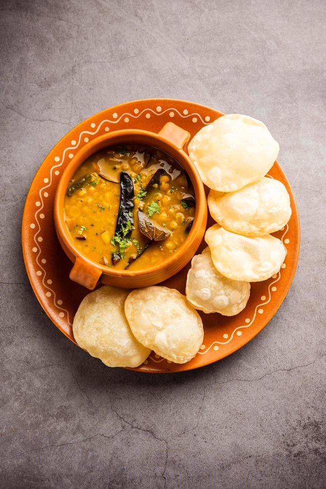 Luchi Cholar Dal or Fried bread made of flour served along with curried Chana or Bengal gram photo