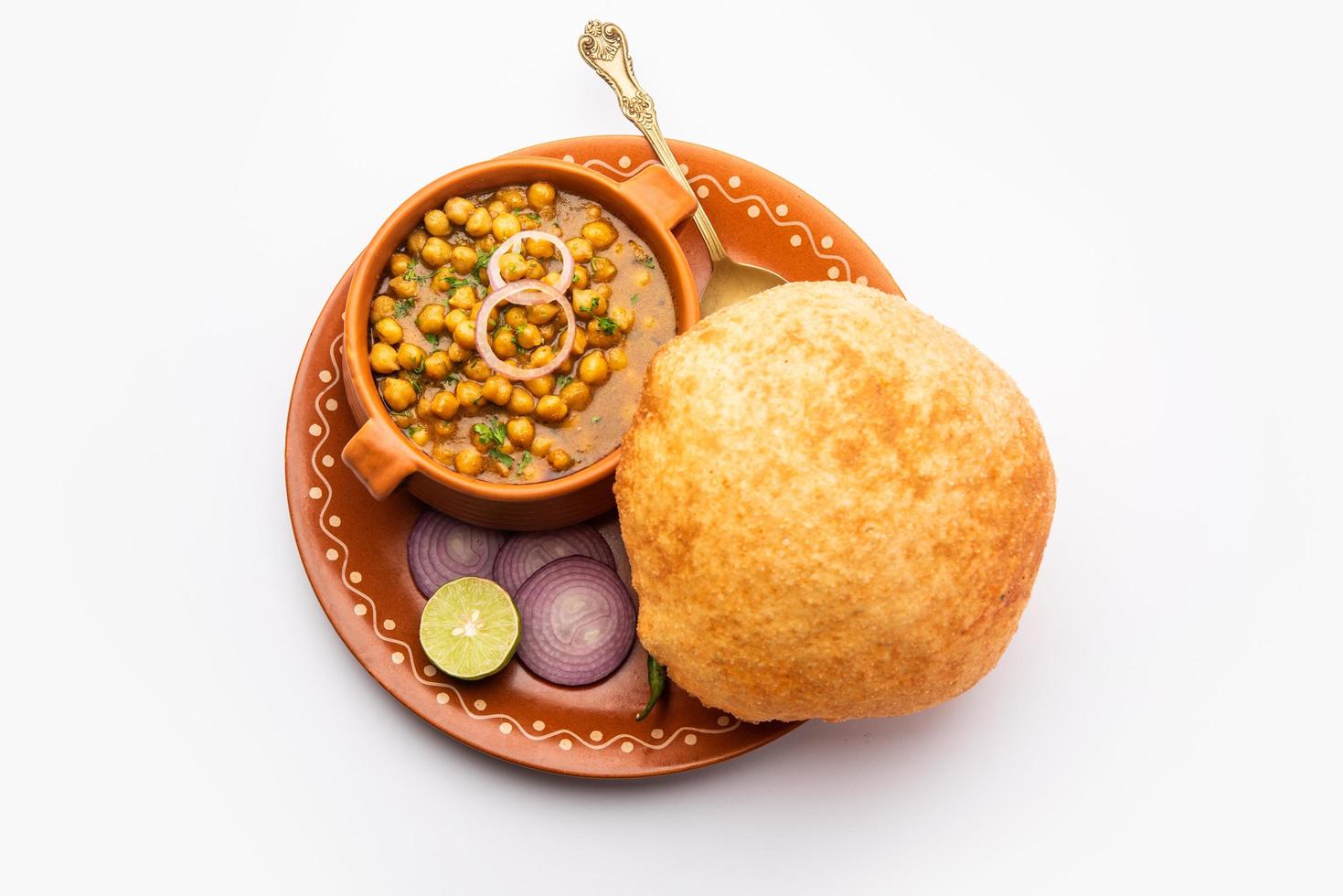 Chole bhature is a North Indian food dish. A combination of chana masala and bhatura or puri photo