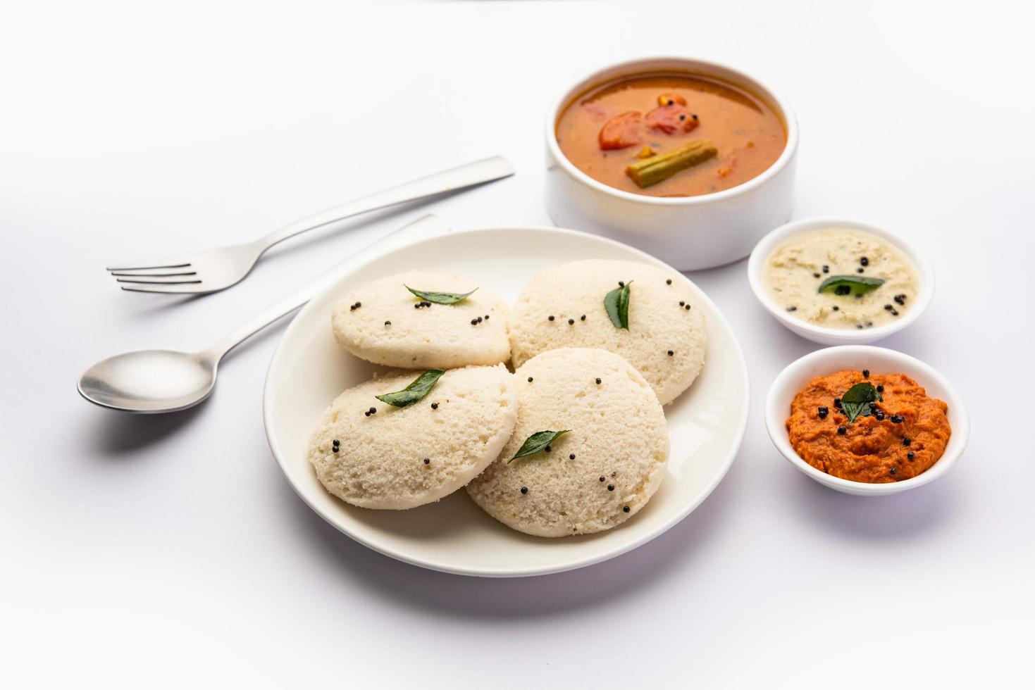 Idly sambar or Idli with Sambhar and green, red chutney. Popular South indian breakfast photo
