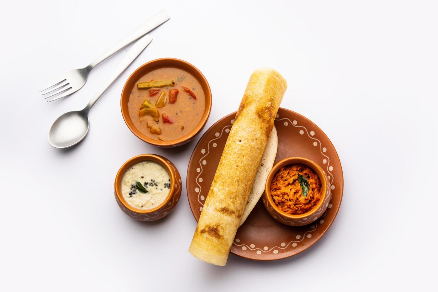 A dosa, also called dosai, dosey, or dosha, is a thin pancake in South Indian cuisine photo