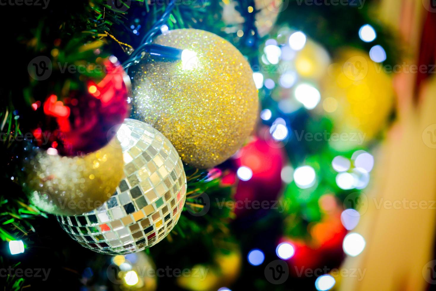 Background for Christmas season. Close-up shot of a beautiful decorated fir tree. photo
