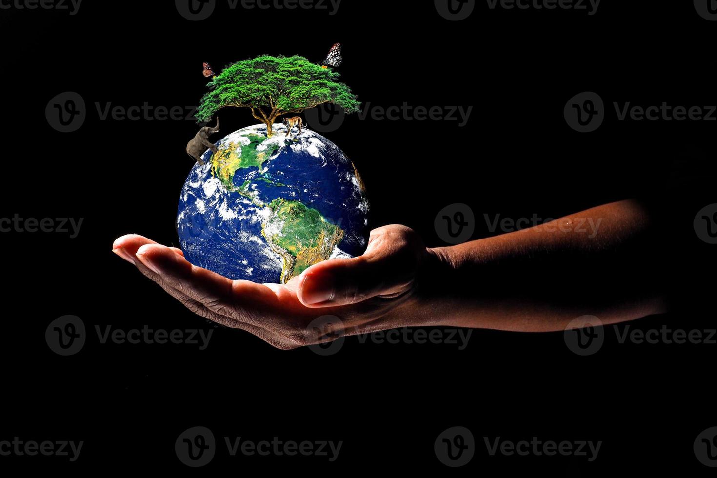 Earth on hand on black background. The concept of loving the earth, protecting the environment photo