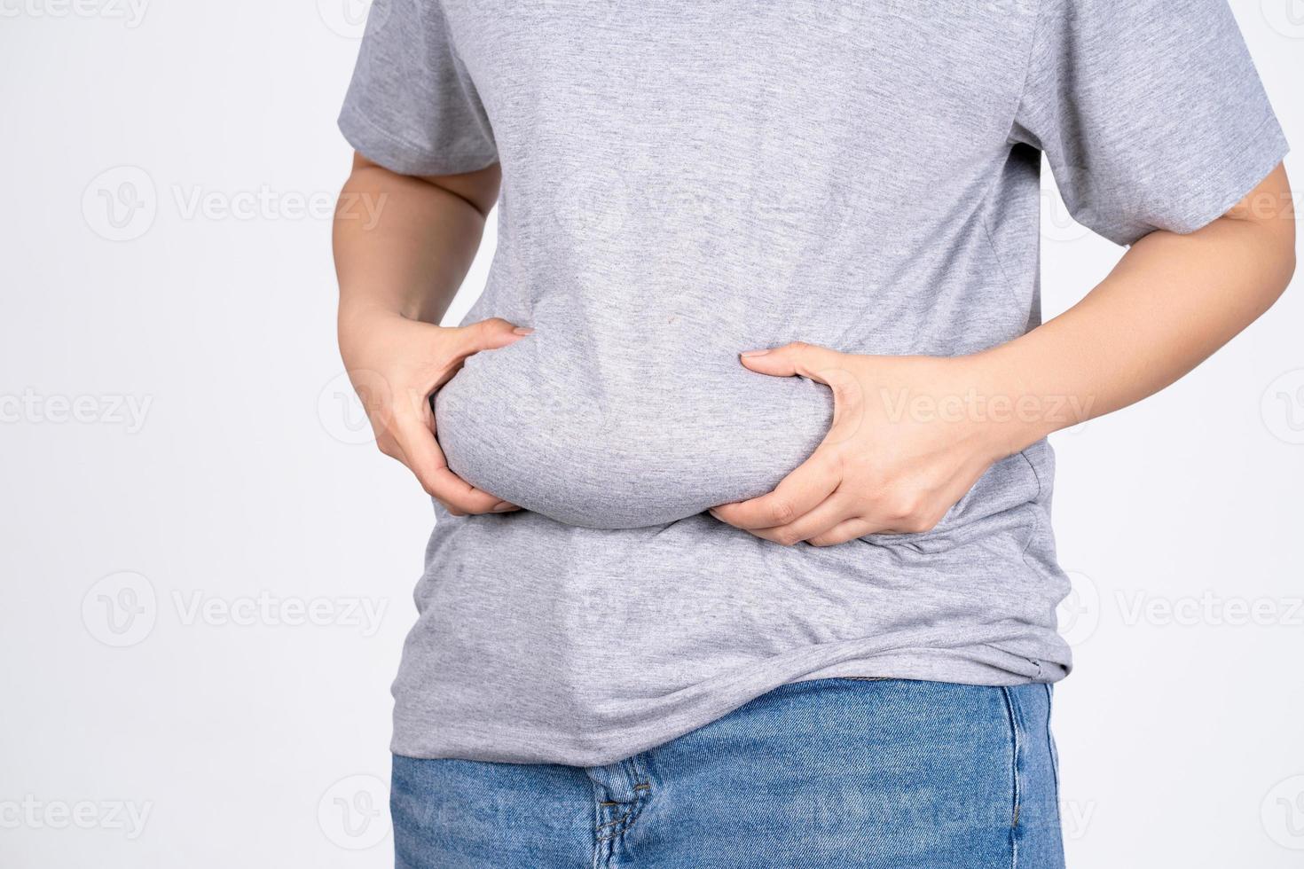 Fat woman, Fat girl, Fat belly, Chubby, woman's hand holding excessive belly fat isolated on white background. concept of surgery and subcutaneous fat breakdown. photo