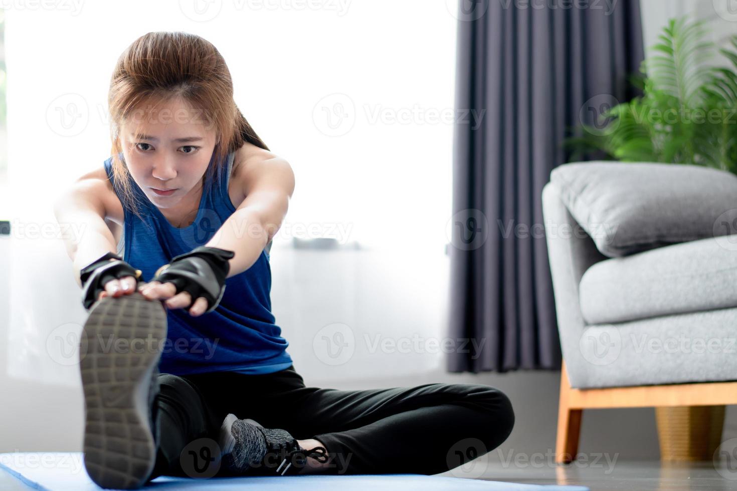 Asian women warm up before exercising at home. Workout from home. photo