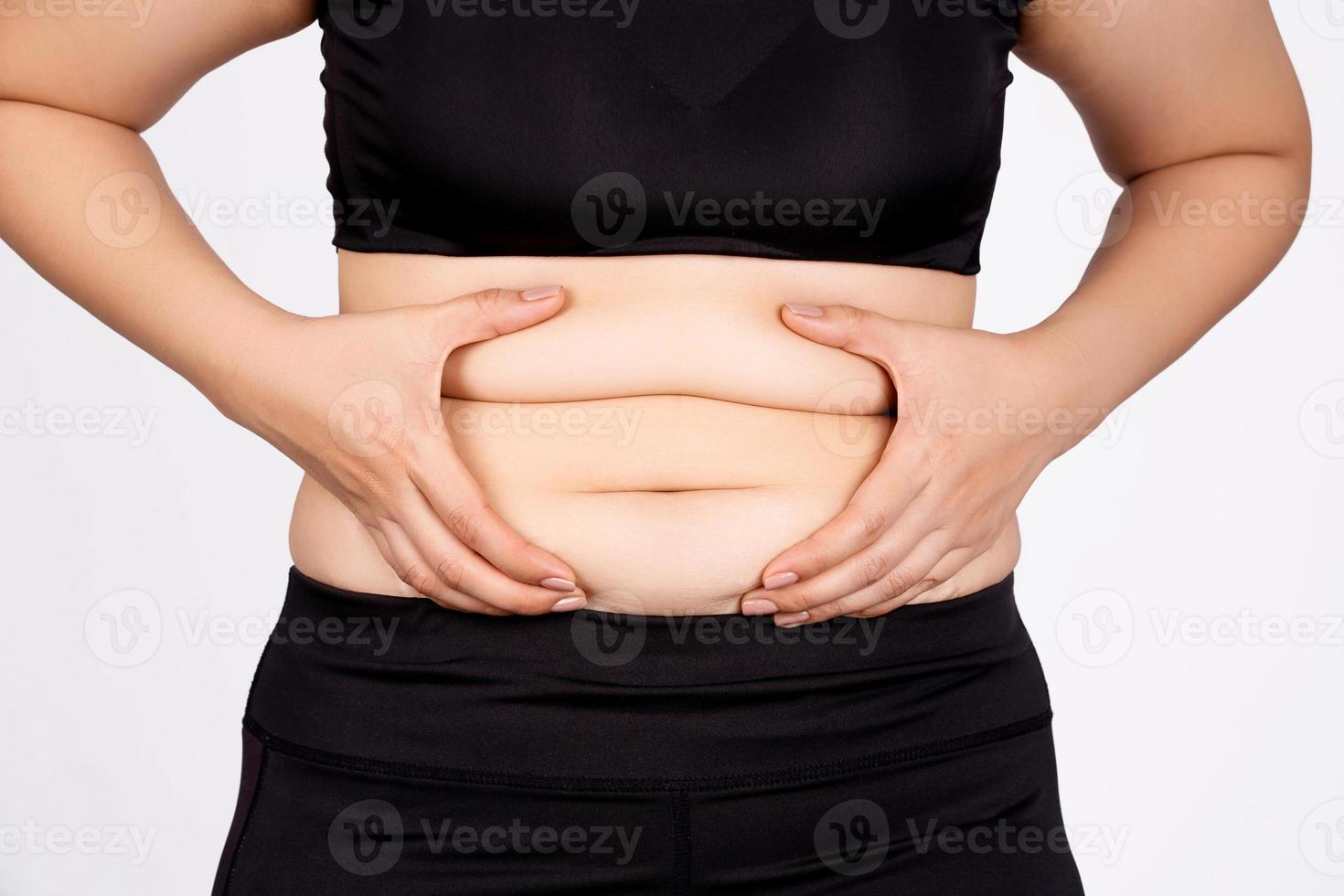Abdominal surface of fat woman on white background. photo