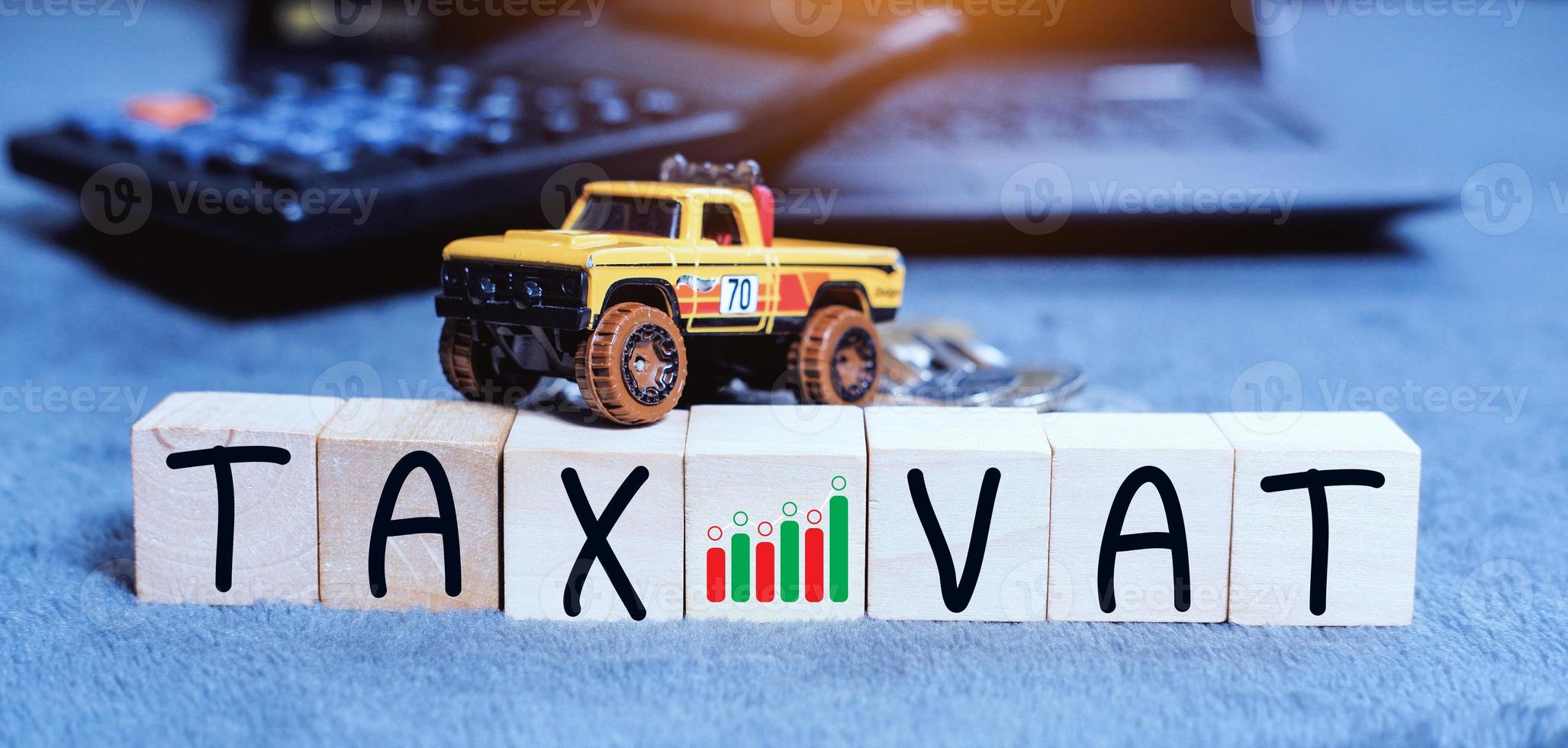 Concept of taxes for car on block cubes paid by individuals and corporations such as VAT, income tax and property tax Data analysis, paperwork,Financial research. photo