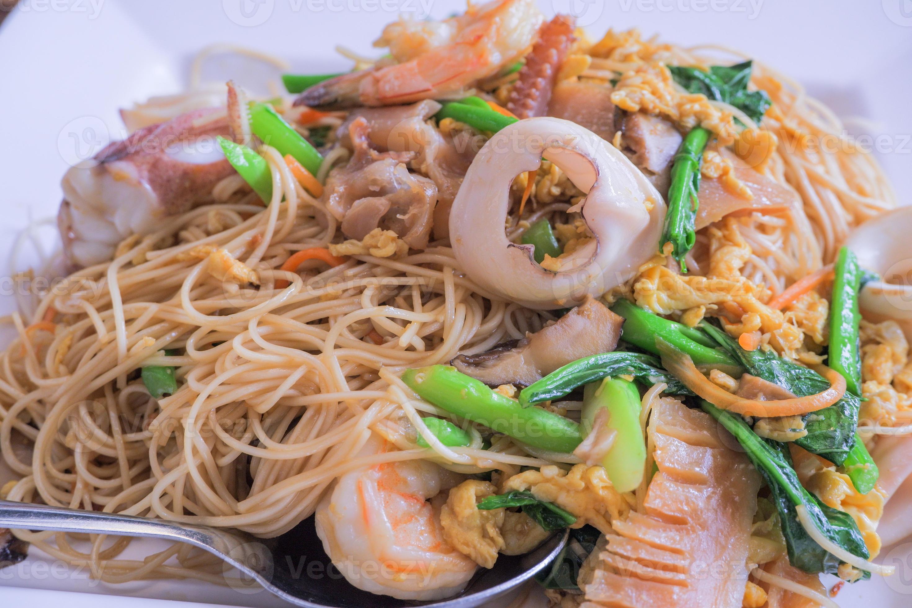 Hong Kong recipe stirfried noodles with egg, fresh squid, shrimp, pickled squid and Hong Kong