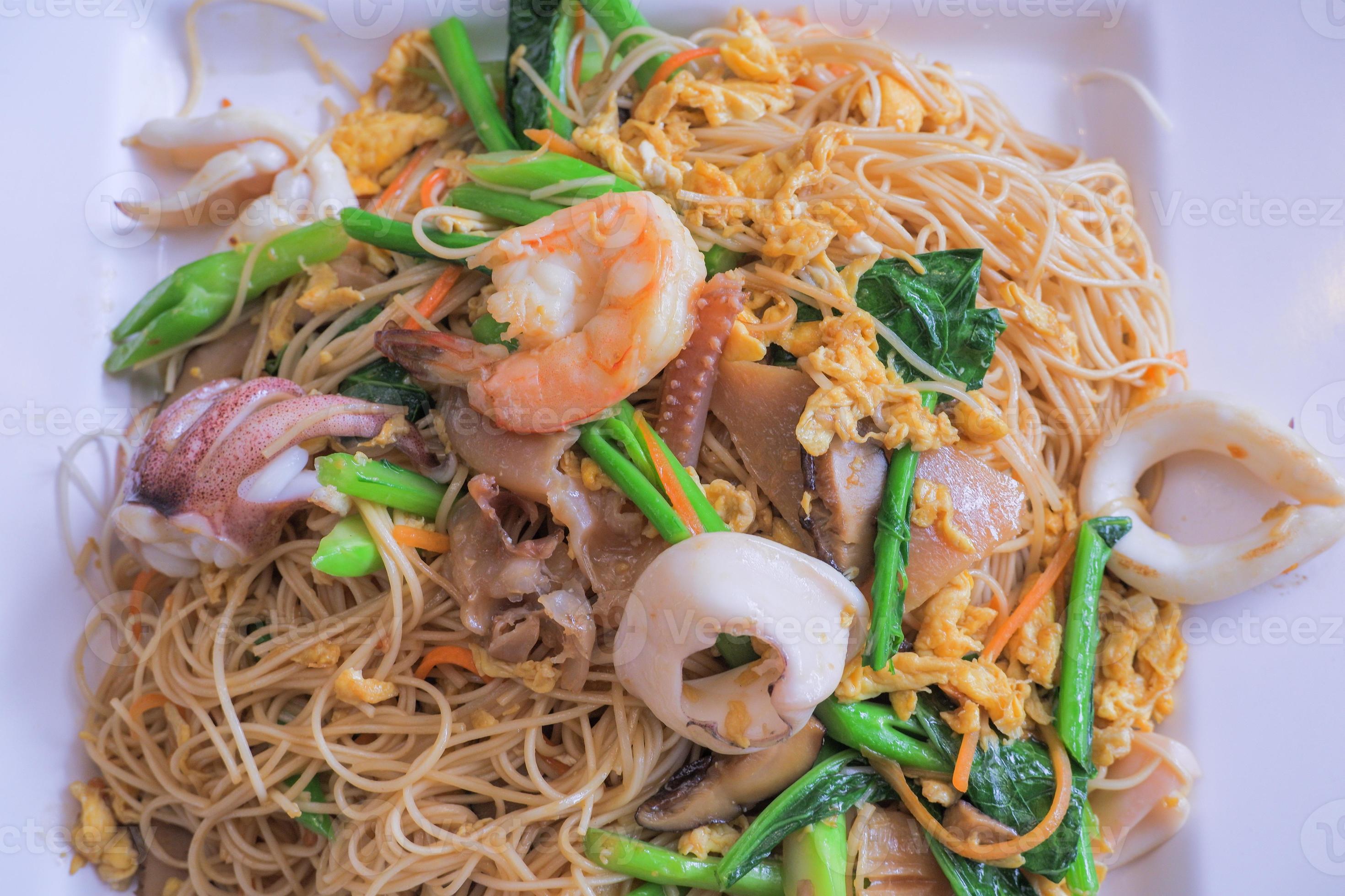 Hong Kong recipe stirfried noodles with egg, fresh squid, shrimp, pickled squid and Hong Kong