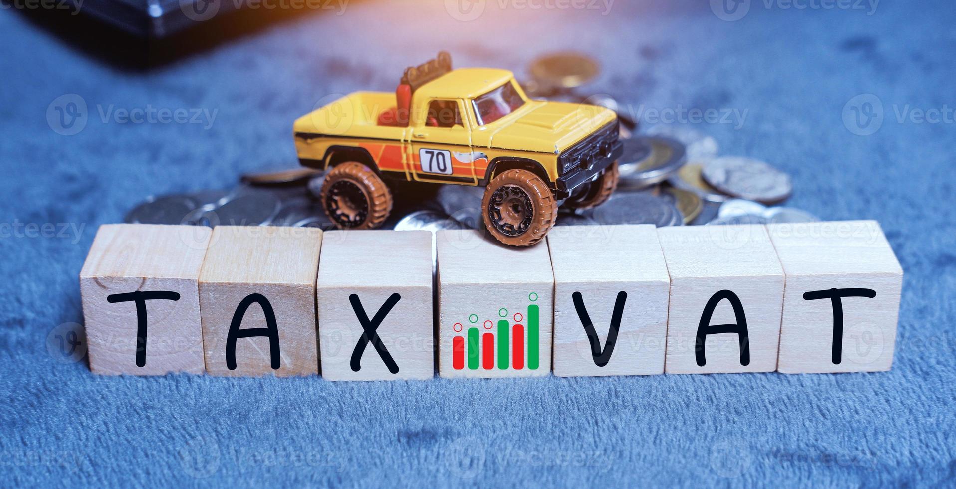 Concept of taxes for car on block cubes paid by individuals and corporations such as VAT, income tax and property tax Data analysis, paperwork,Financial research. photo