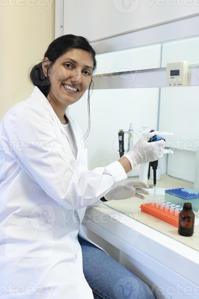 Scientist working in a fume cupboard in laboratory research. photo