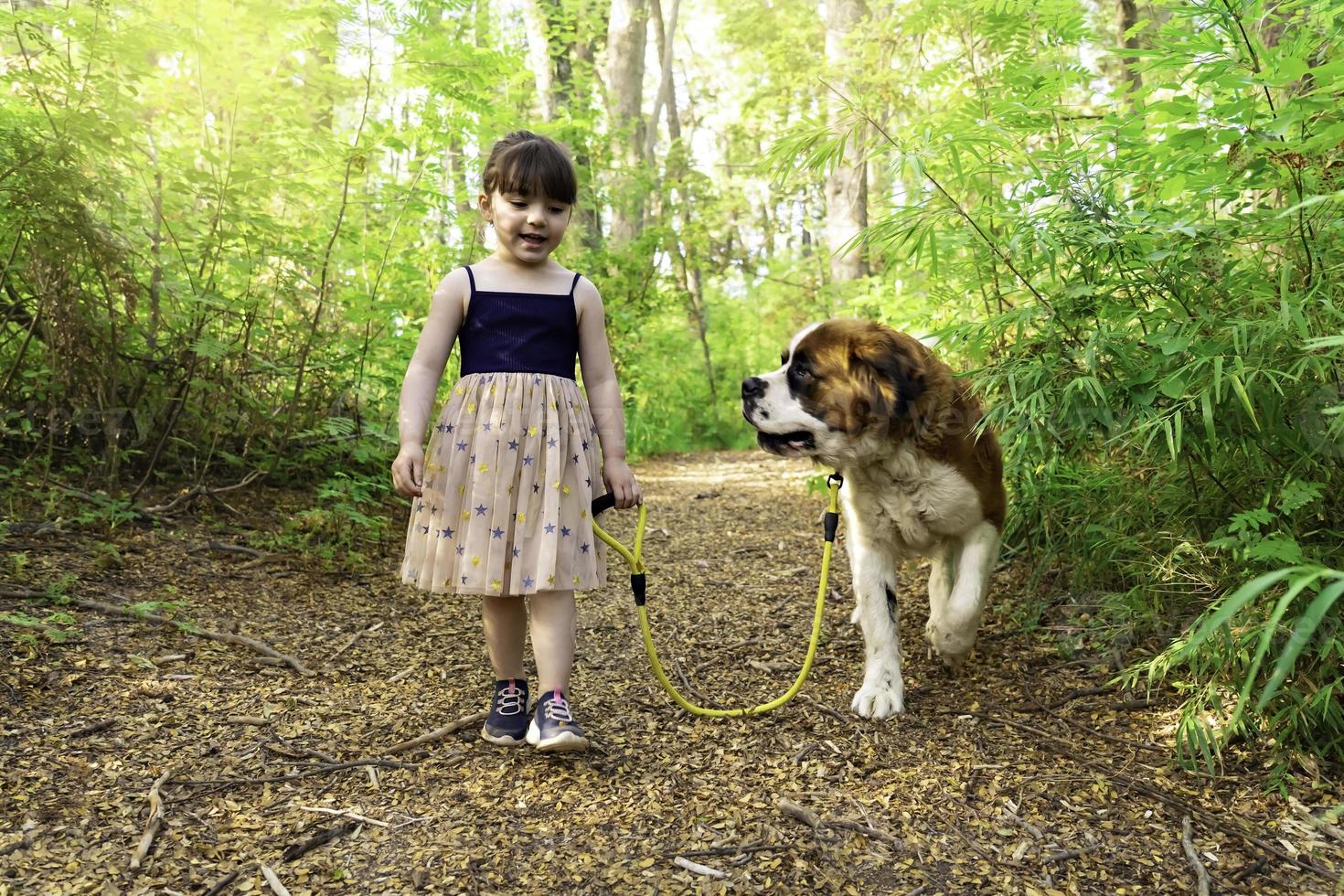 Cute girl walking with dog photo