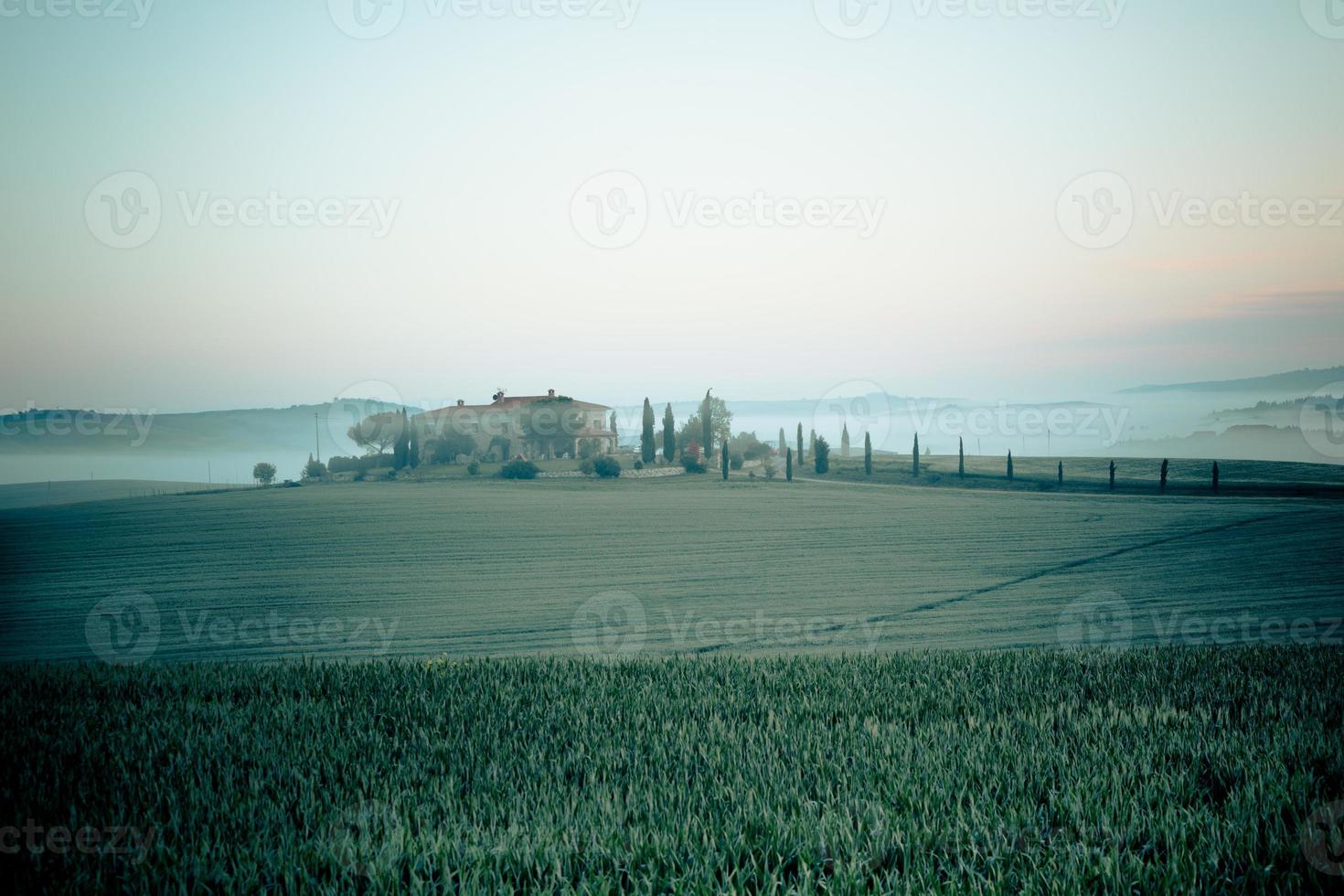 Morning fog view on farmhouse in Tuscany, Italy photo