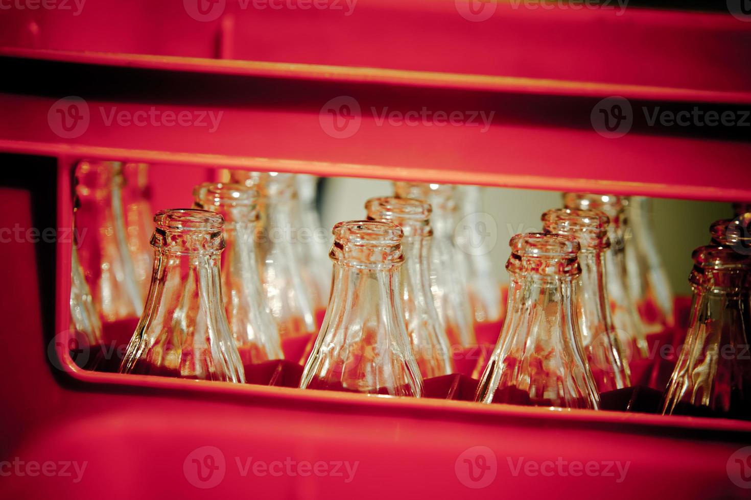 Red Plastic Crate with Empty Glass Bottles photo