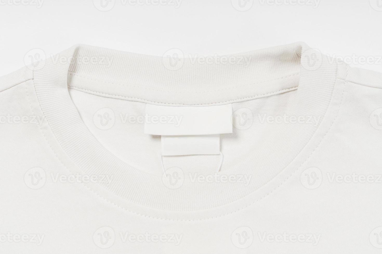 Closeup of cotton white t-shirt and hem tags photo