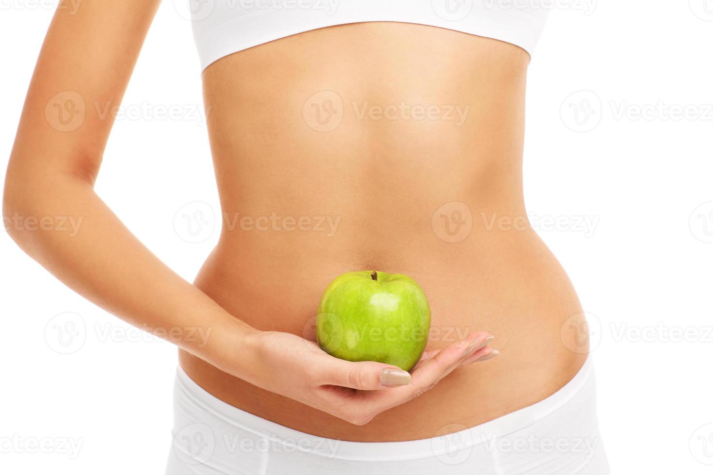Green apple over belly photo