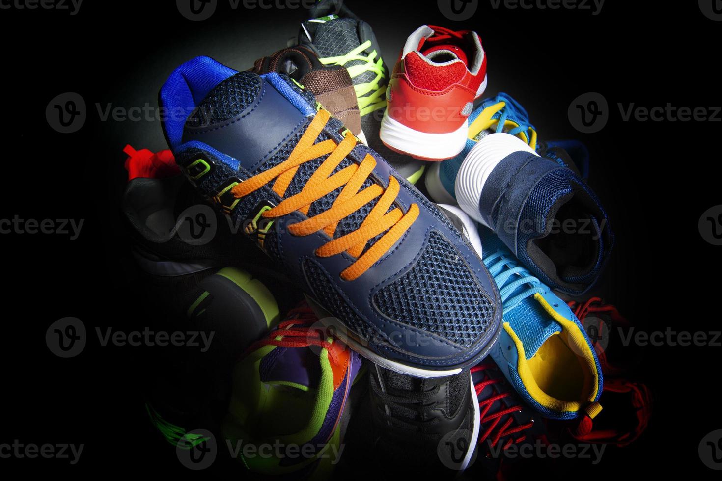 Sport shoes. Various sneakers on a dark background. photo