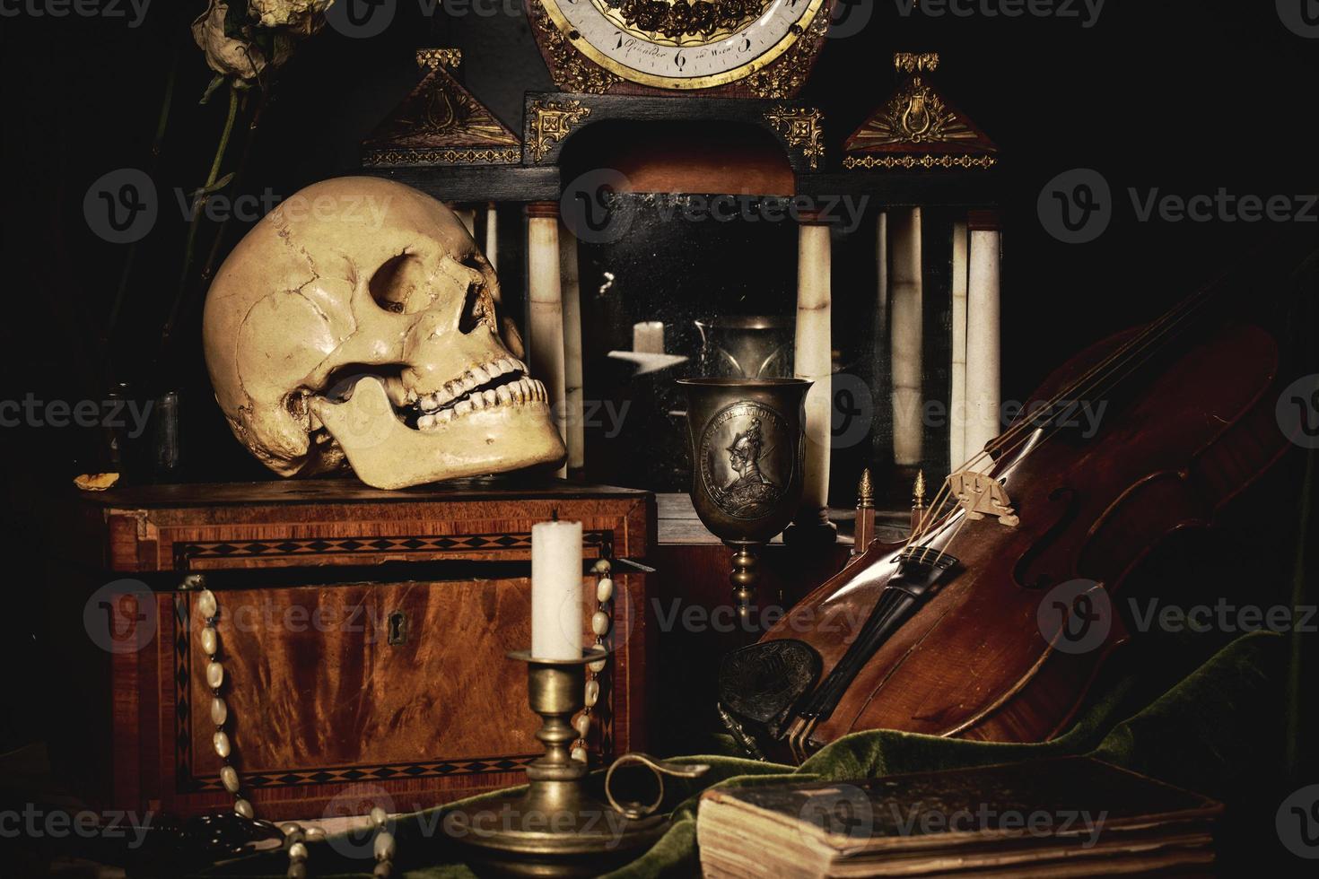 Close-up still life, Dutch painting of the 17th century. On the table on a black background are flowers, a skull, a clock, a violin, keys. Things that tell about a person's life. photo