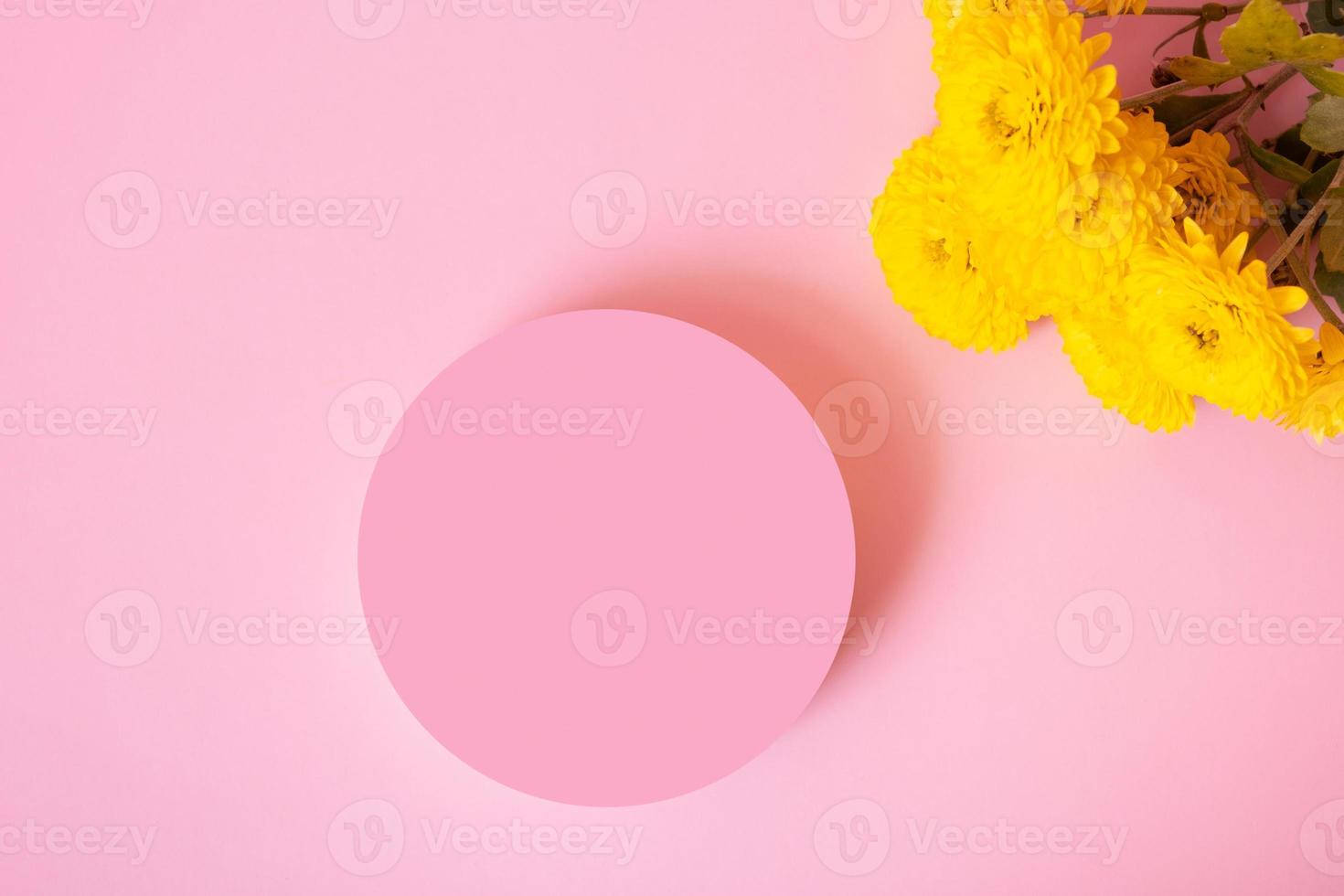 Podium or pedestal with chrysanthemum flowers top view. Mockup for your cosmetic products photo