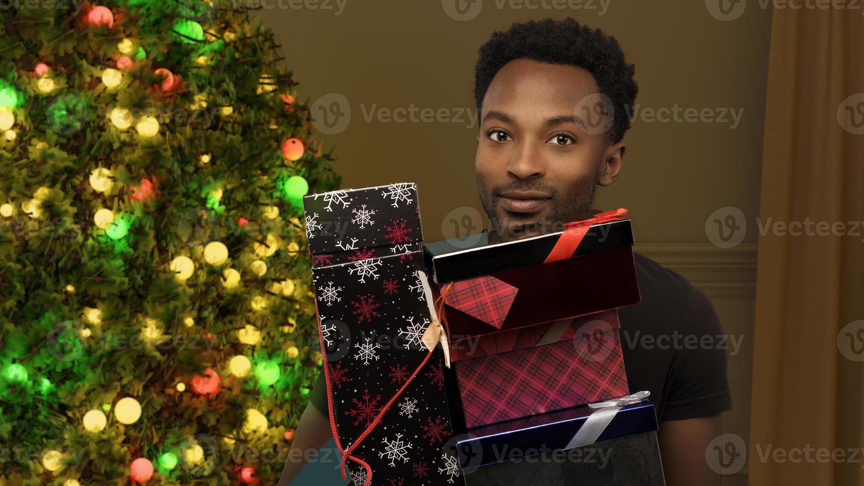 man holding christmas gifts many boxes stack fir tree illuminated lights decorations holiday abundance photo